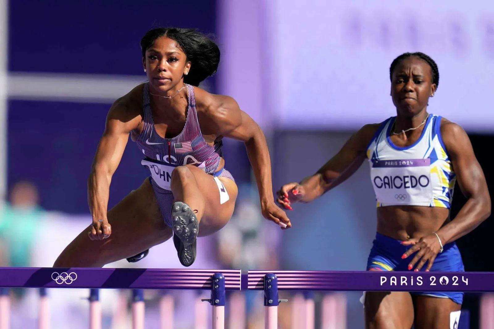 Alaysha Johnson in Team USA kit clears a hurdle at the Paris 2024 Olympic Games.