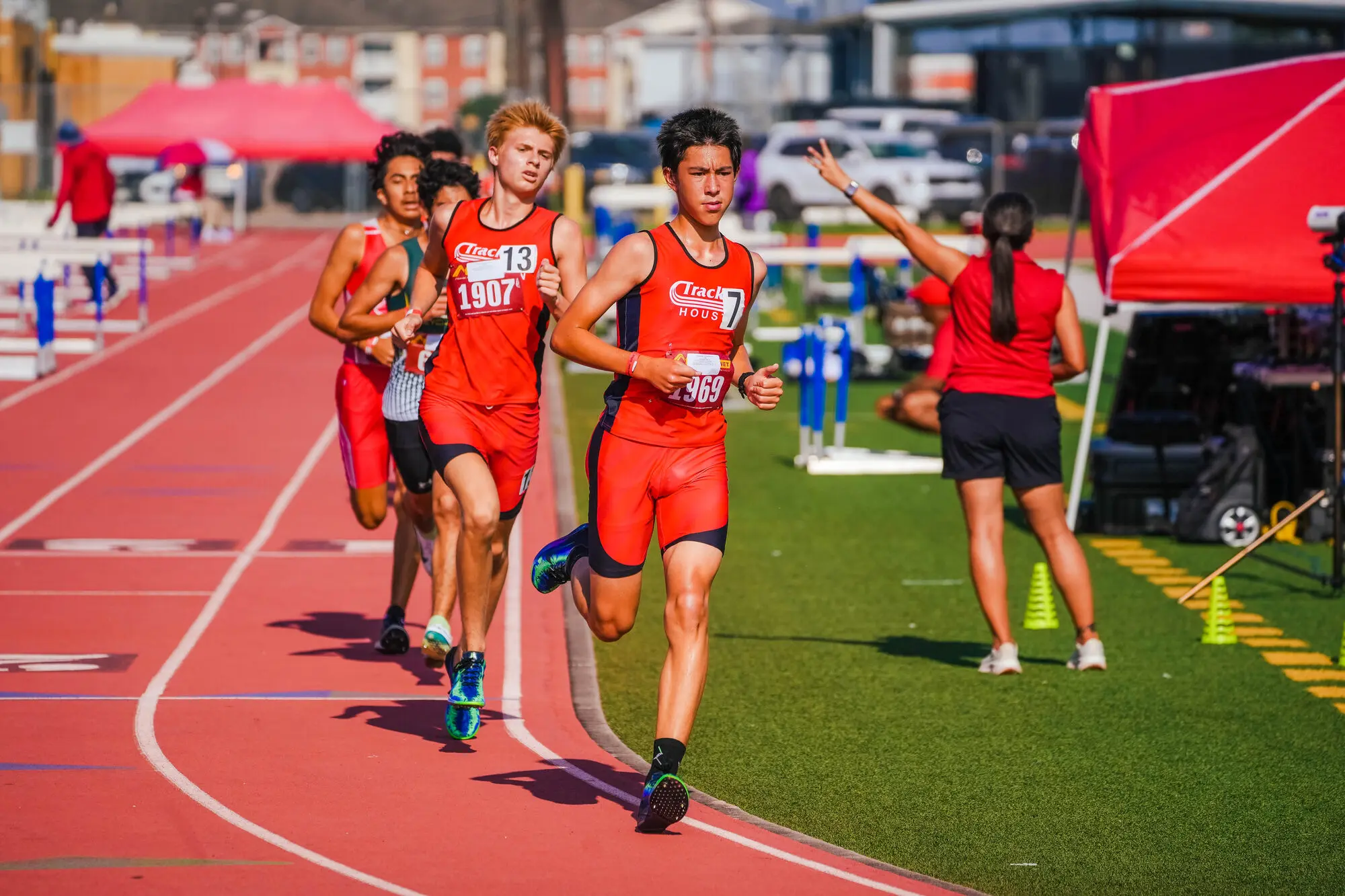 Track Houston runners training in a group on a Houston-area track.