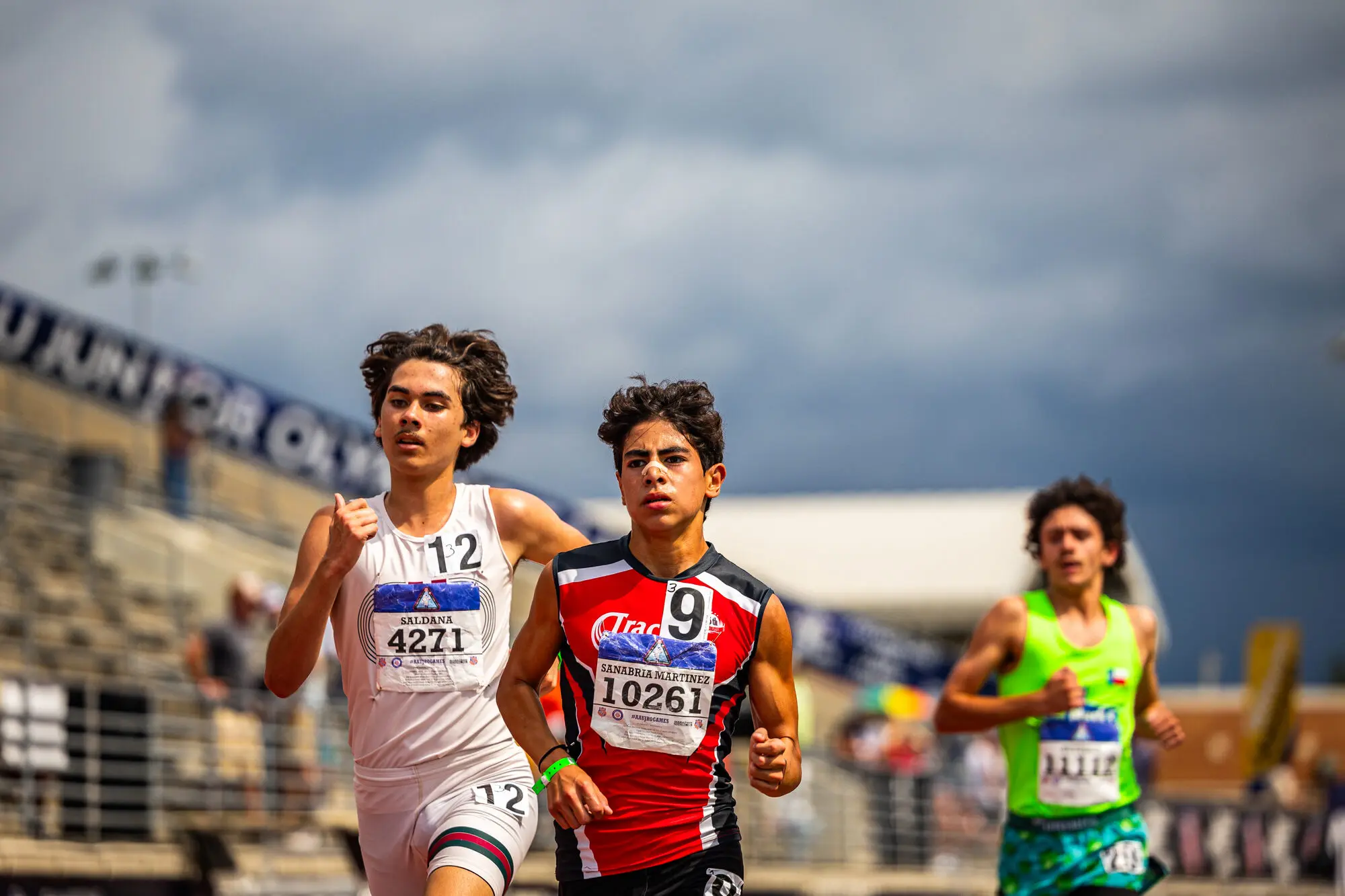 A Track Houston middle-distance runner battles for position in a championship race.