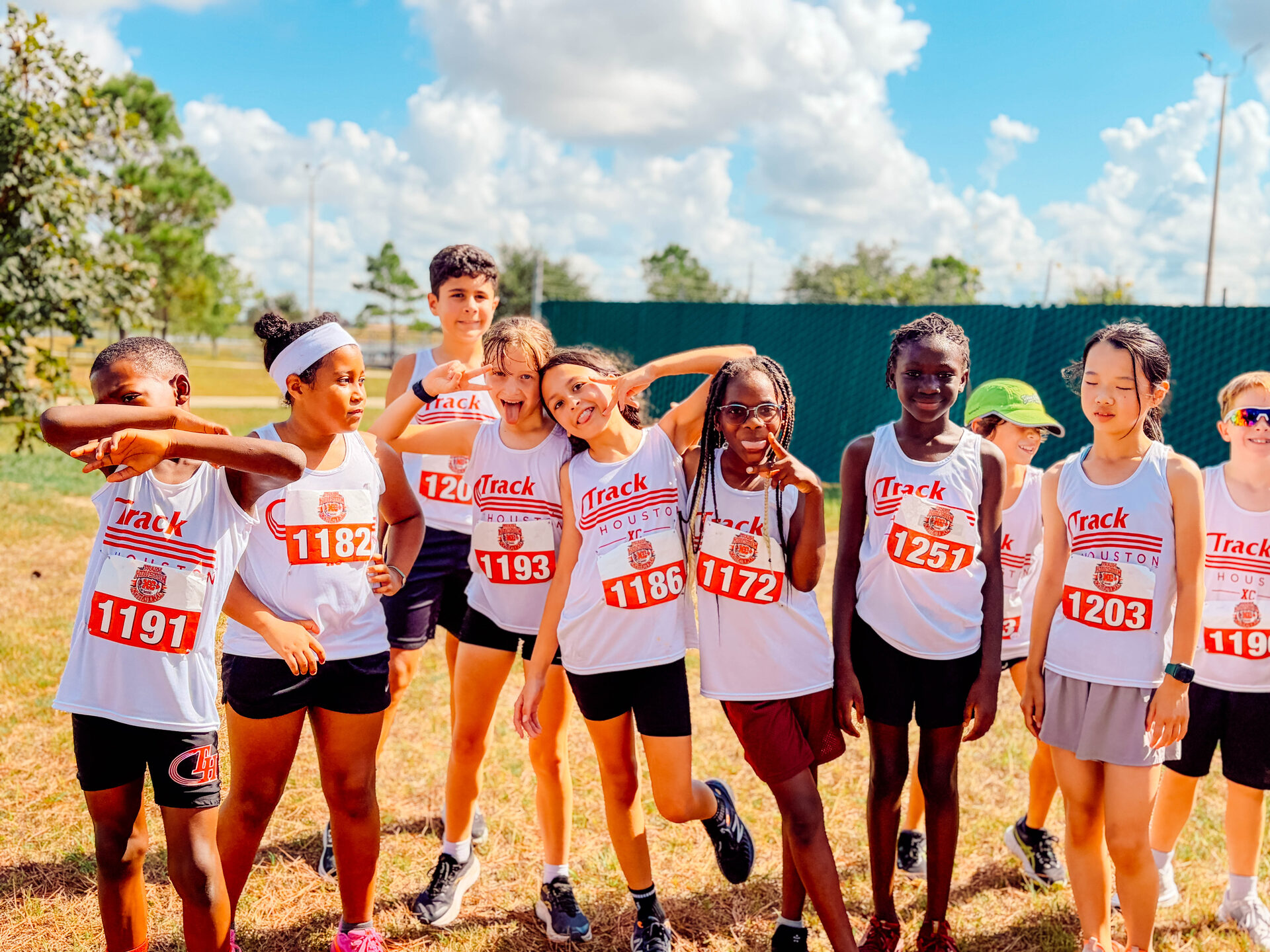 Track Houston cross country squad in white singlets lined up before the race.